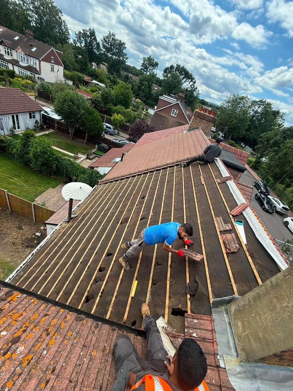 Roofers working across a battened roof slope