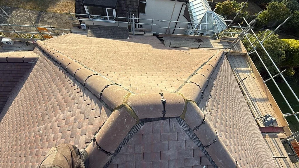 Brown tile hip and valley junction above scaffold