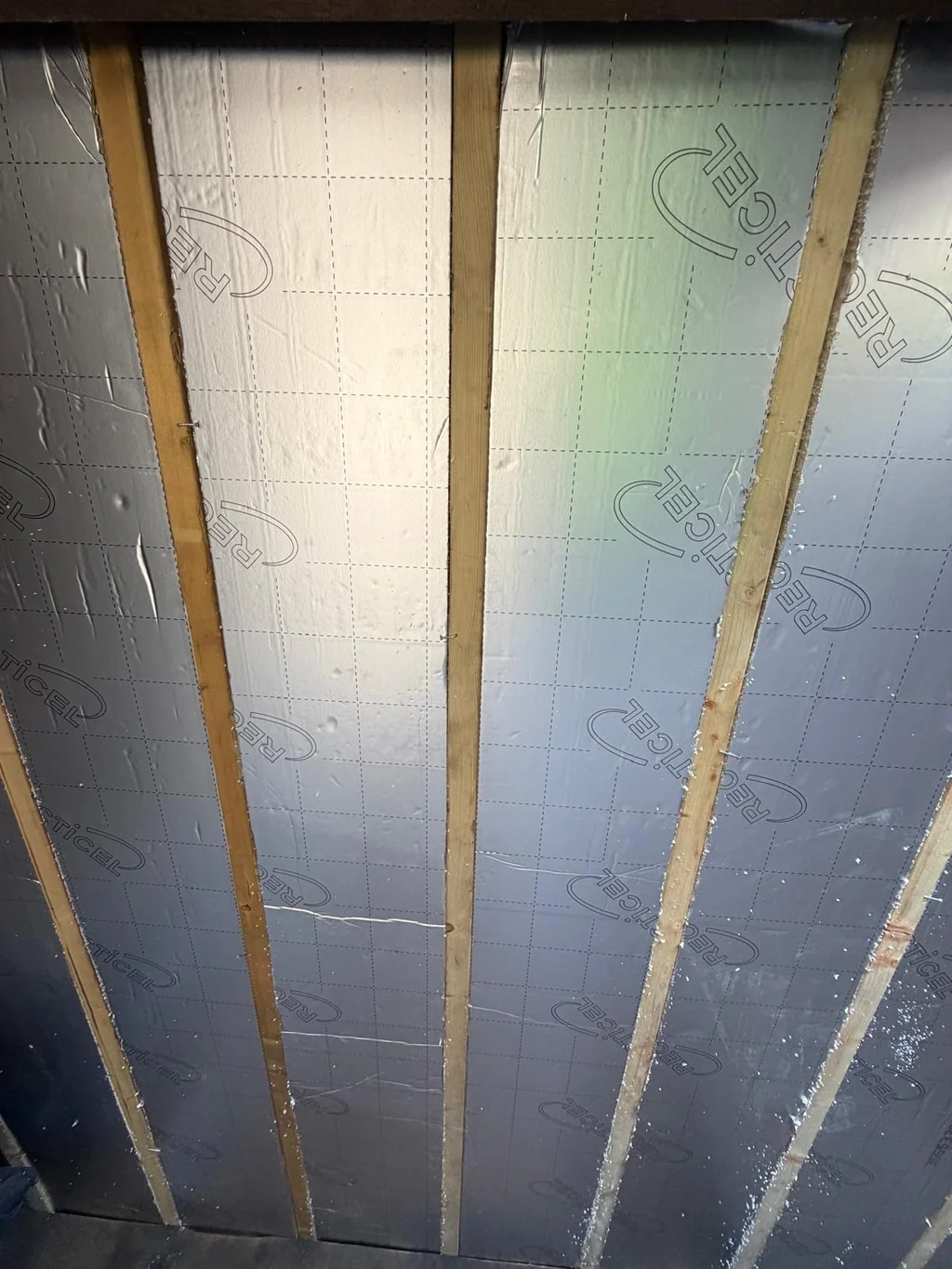 Foil-faced insulation boards fitted between timber battens